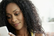 © PhotoAlto - Woman using mobile phone