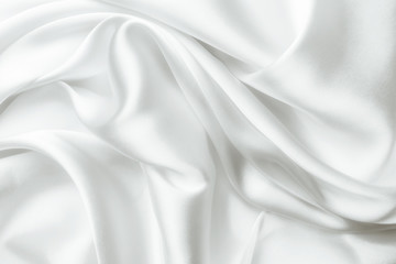 Elegant white satin silk with waves, abstract background.