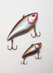 Fishing lure with hooks. Wobbler on silver background.