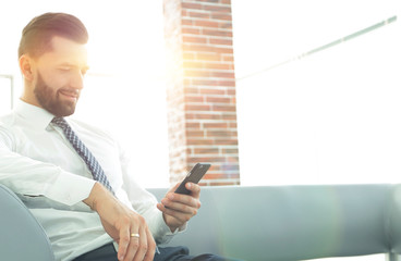 Serious businessman sitting at office desk in office