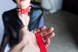 Male hand hold red leash with chain