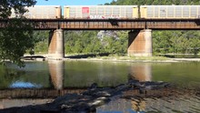 A Freight Train Travels Over A Bridge Loaded With Cargo In West Virginia.