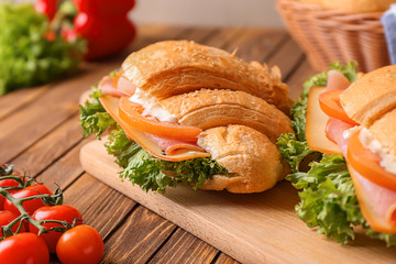 Sticker - Tasty croissant sandwiches on wooden board