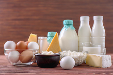 Wall Mural - Different dairy products and eggs on wooden table