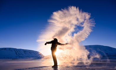 Wall Mural - boiling water frost in polar arctic sky in norway svalbard in longyearbyen man mountains