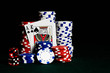 Stacks of poker chips on a gambling table with an ace and king representing a Blackjack win playing the game 21