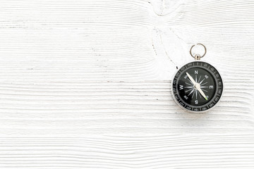 Wall Mural - Compass on white wooden background top view copy space