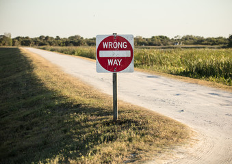 wrong way sign is warning you to turn back from your path