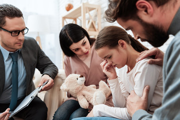 Wall Mural - Young couple came with daughter to reception of child psychologist. Psychological help to children.