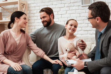 Happy family of three talking with psychologist. Family psychotherapy concept.