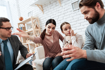 Wall Mural - Young woman asks bearded man to leave her and daughter pointing to exit at psychologist's office.