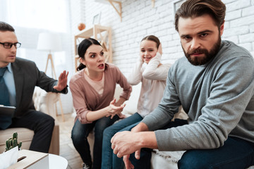 Wall Mural - Young mother argues with husband when daughter is crying at psychologist's office.