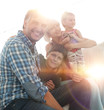 © ASDF - family with two children sitting together and looking at camera