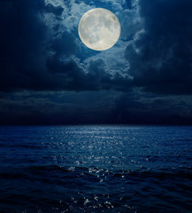 Poster - super moon in dark clouds over sea