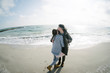 © LIGHTFIELD STUDIOS - young couple hugging on winter seashore