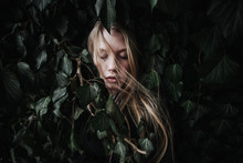 Portrait Of A Woman Hiding In Ivy
