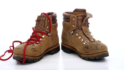 Wall Mural - stop-motion shoelaces with boots on white background