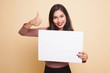 Young Asian woman show thumbs up with  white blank sign.