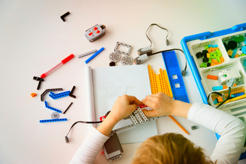 Poster - little boy building robot at robotic technology lesson