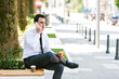 © Alvin Harambašić - Young businessman talking on cellphone while eats sandwich and drink coffee to go