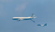 Israeli fighter jet and tanker in air refueling. The Jets flight from right to left in formation.