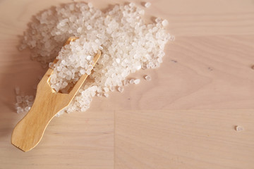 Spa concept. White bath salt on the whit wooden background 