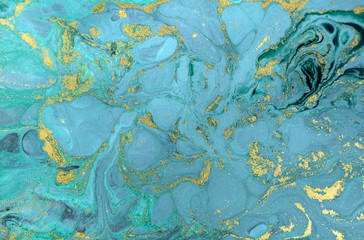 Marble abstract acrylic background. Nature blue marbling artwork texture. Golden glitter.