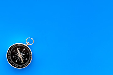 Wall Mural - Compass on blue background top view copy space