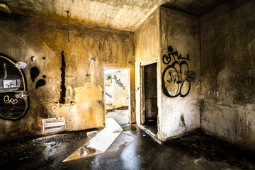 abandoned farm building with graffiti on the wall