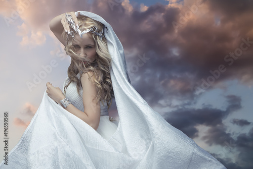 Mythology, Greek goddess, blond woman with silver laurel wreath dressed in white silks in the wind Tableau sur Toile