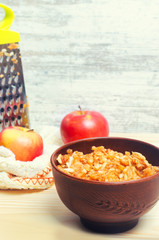 Grated apple in a plate. vitamins of iron. a metal grater. healt