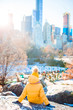 © travnikovstudio - Adorable little girl with view of ice-rink in Central Park at New York City