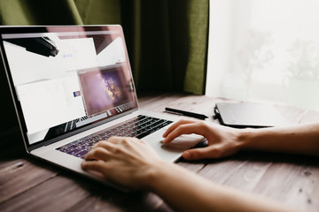 Fototapete - Man freelancer is working using laptop computer at home office. Freelance lifestyle workplace