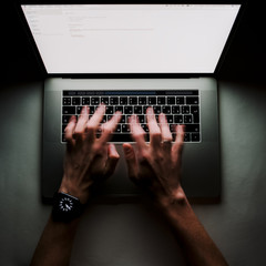 Fototapete - Man is working typing use laptop computer at dark night. Writer flat lay top view workplace