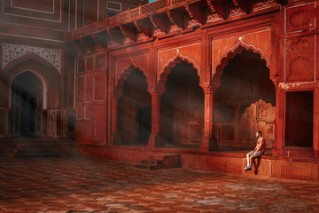 young guy sitting under the rays of the morning sun and watching the taj mahal mosque