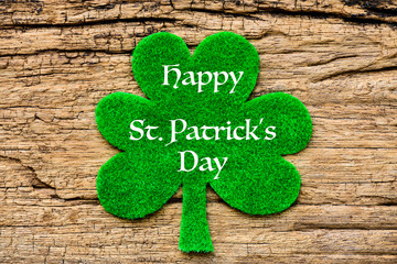 Wall Mural - Happy St Patricks Day message with green clover leaf on wooden background