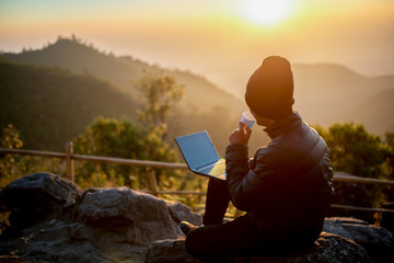 Wall Mural - Traveller drinks coffee in morning with landscape view