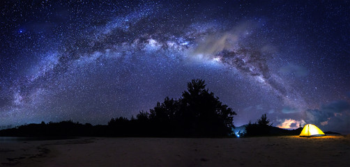 stitched panorama of bright milky way during clear night sky for background. image contain soft focu