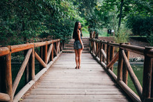 Young Woman On Wooden Bridge