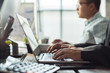 © torwaiphoto - Hand of employees are working in the office. His computer is entering financial data.