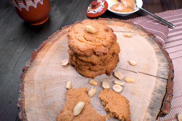 Sweet healthy peanut cookies on wooden table with honey