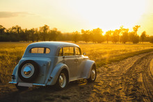 Car At Sunset In The Field