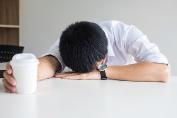 Poster - Tired businessman sleeping at work in modern office with hand holding coffee cup, people dozing on workplace