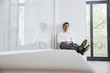 © Westend61 - Businessman relaxing on bench in modern office