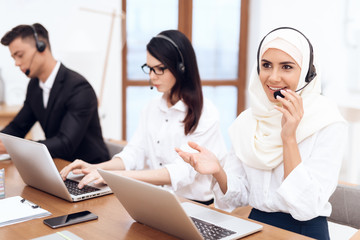 Wall Mural - An Arab woman works in a call center.