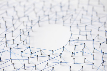 Sticker - A large grid of pins connected with string. Communication, technology, network concept