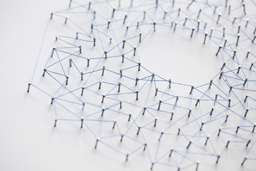 Poster - A large grid of pins connected with string. Communication, technology, network concept