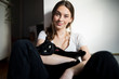 © GAM Studios - Happy young woman holding black cat