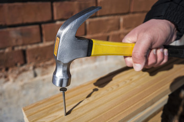 Hammer and nails on wood