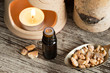 A bottle of styrax benzoin essential oil with benzoin resin and an aroma lamp